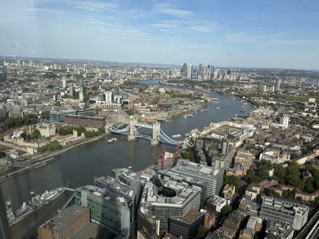 Aerial view of London featuring the River Thames, Tower Bridge, and the surrounding cityscape.